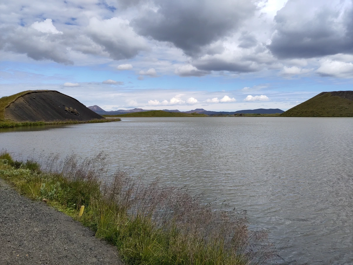 Seeufer mit zwei dunklen Kraterhügeln am Mývatn